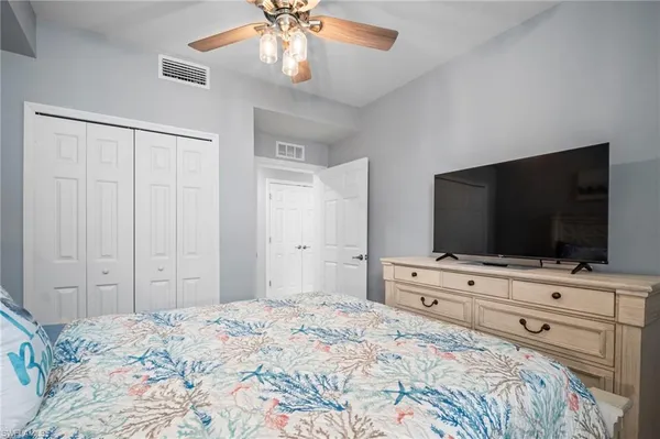 a bedroom with a bed and a flat screen tv in it