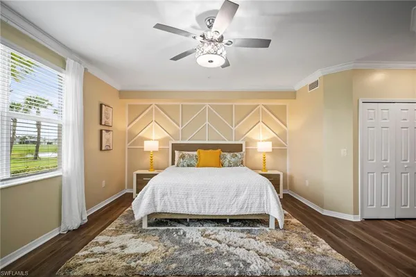 a bedroom with a bed and a chandelier