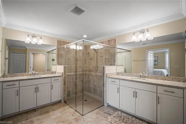 a bathroom with a sink double vanity and a mirror