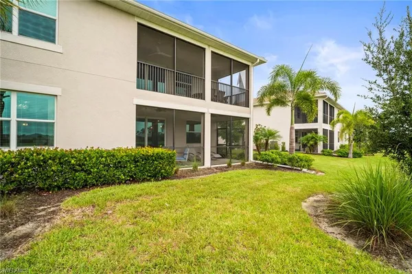 a front view of a house with yard and green space