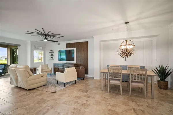 a living room with furniture a chandelier and a window