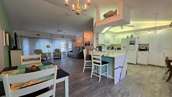 a living room with lots of furniture and kitchen view