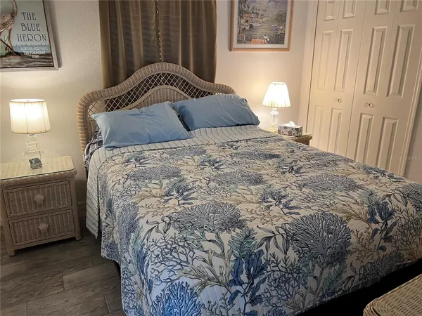 a bedroom with a bed and cabinet