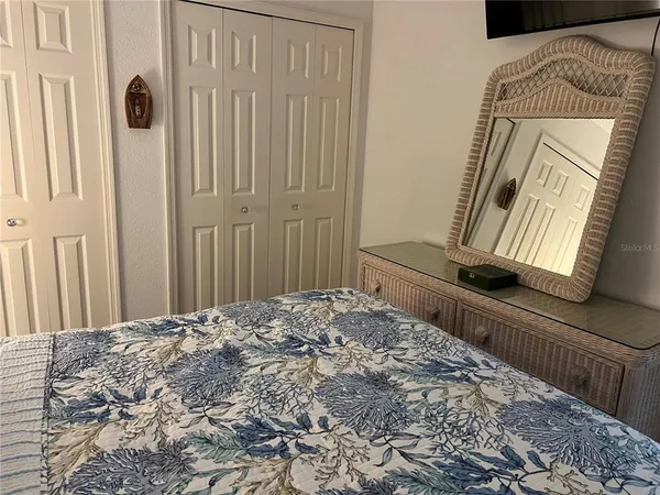 a bedroom with a bed and a mirror
