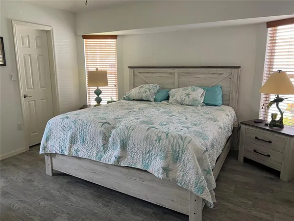 a spacious bedroom with a bed and window