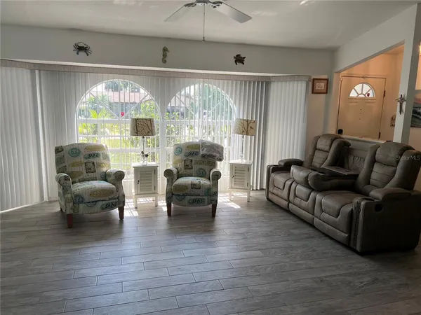 a living room with furniture and a large window