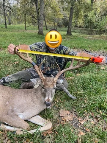 an aerial view of a house with a yard and tennis court