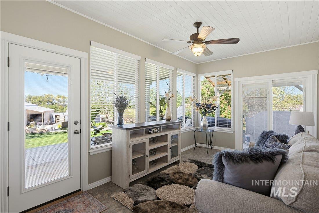 24623 Falcon Lane Caldwell, ID 83607 - Photo 22 of 40 Sunroom featuring white planked ceiling, light-colored walls, ceiling fan, and multiple windows with blinds