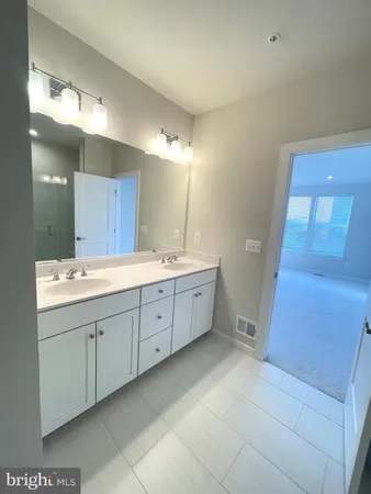 a bathroom with a double vanity sink and mirror