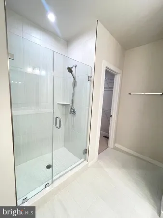 a bathroom with a glass door shower