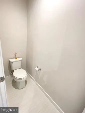 a white toilet sitting next to a white sink