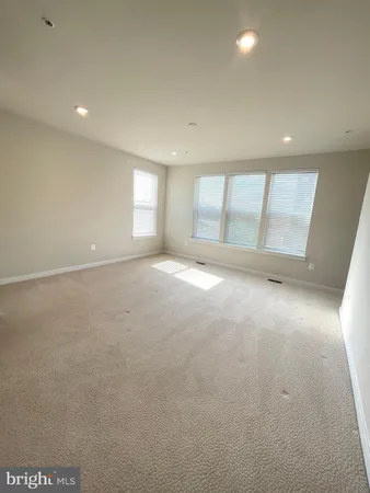 an empty room with a empty space and windows