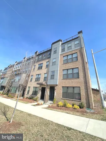 a front view of a residential apartment building with a yard