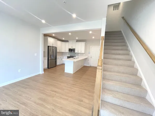 a view of kitchen with wooden floor and electronic appliances
