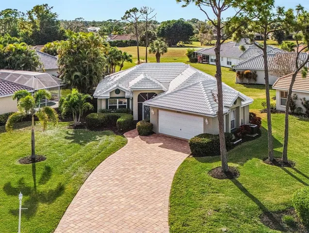 a aerial view of a house with a yard table and chairs