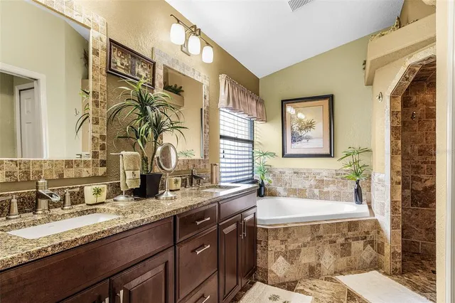 a front view of a house with a yard and palm trees