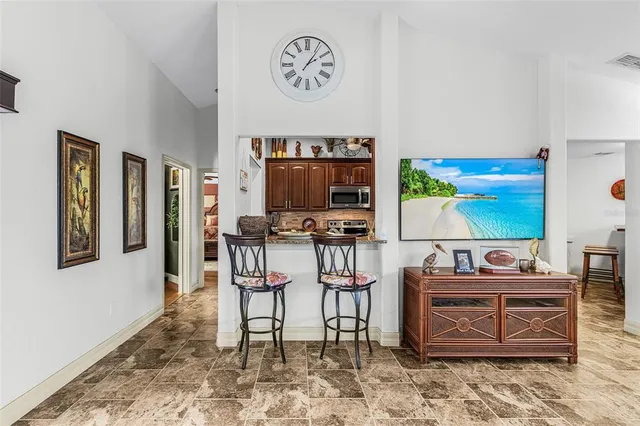 a kitchen with stainless steel appliances granite countertop a refrigerator a stove top oven a sink and dishwasher