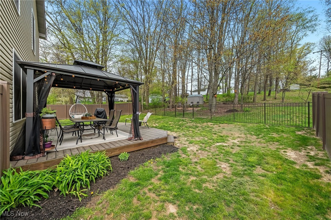 1247 Derbydale Road Akron, OH 44306 - Photo 33 of 45 View of yard featuring a gazebo, outdoor dining area, a wooden deck, and a fenced backyard