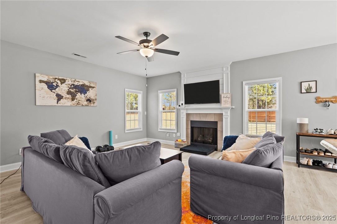 6438 Calloway Road Aberdeen, NC 28315 - Photo 18 of 50 a living room with furniture a fireplace and a flat screen tv