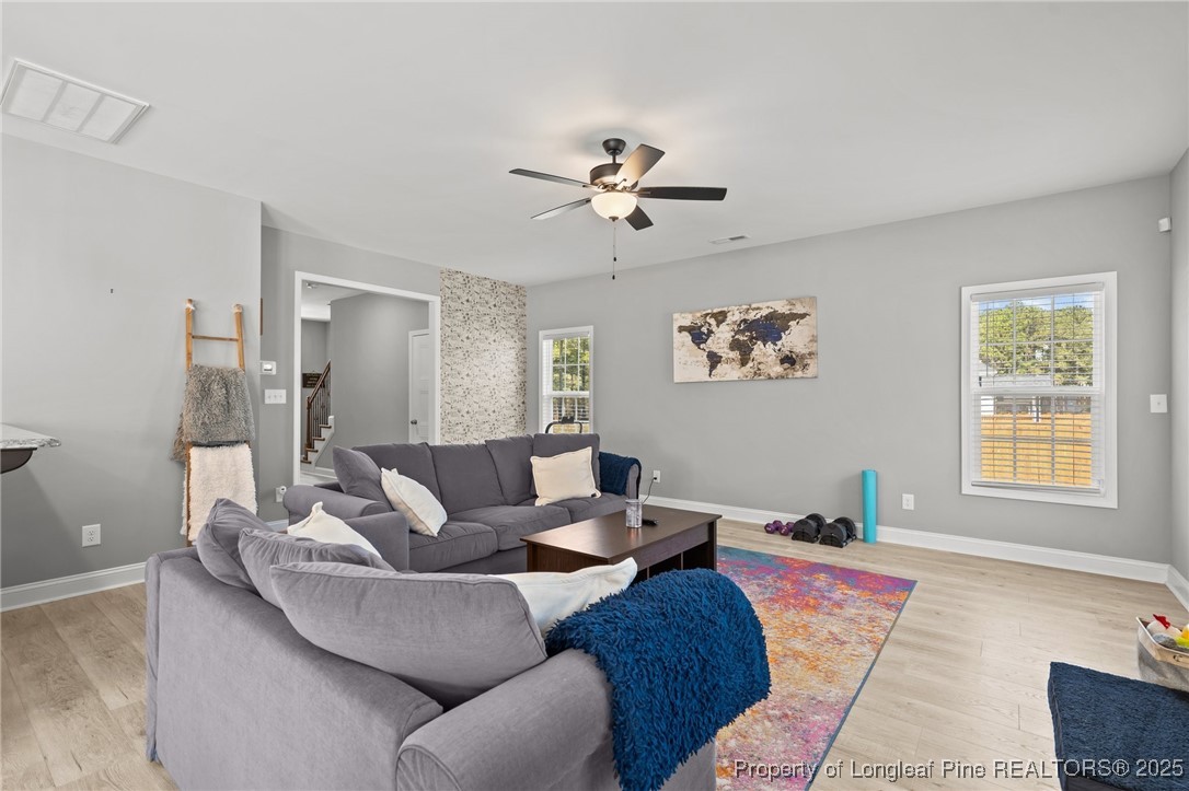6438 Calloway Road Aberdeen, NC 28315 - Photo 19 of 50 a living room with furniture a chandelier and a window