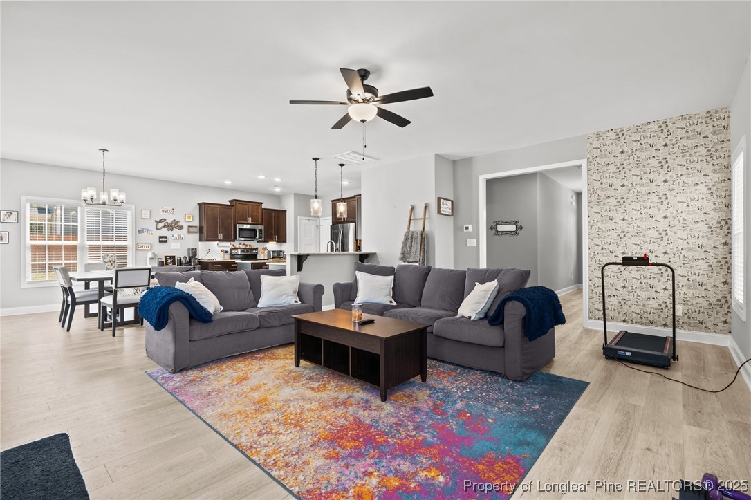 6438 Calloway Road Aberdeen, NC 28315 - Photo 20 of 50 a living room with furniture and a chandelier