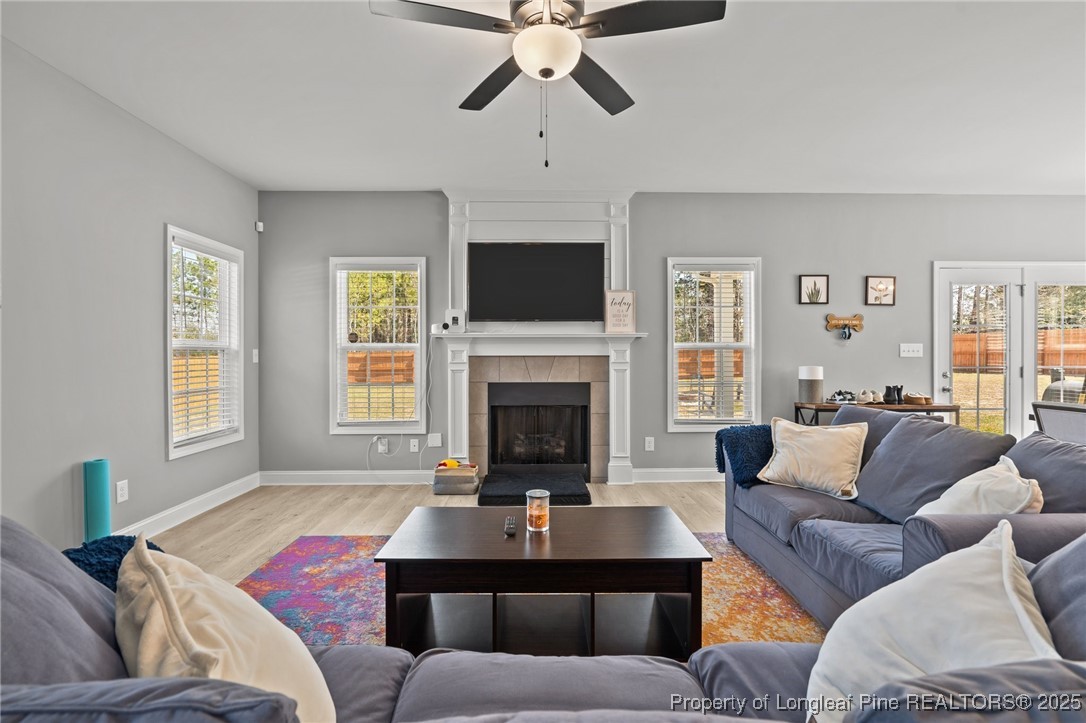 6438 Calloway Road Aberdeen, NC 28315 - Photo 21 of 50 a living room with furniture a fireplace and a flat screen tv