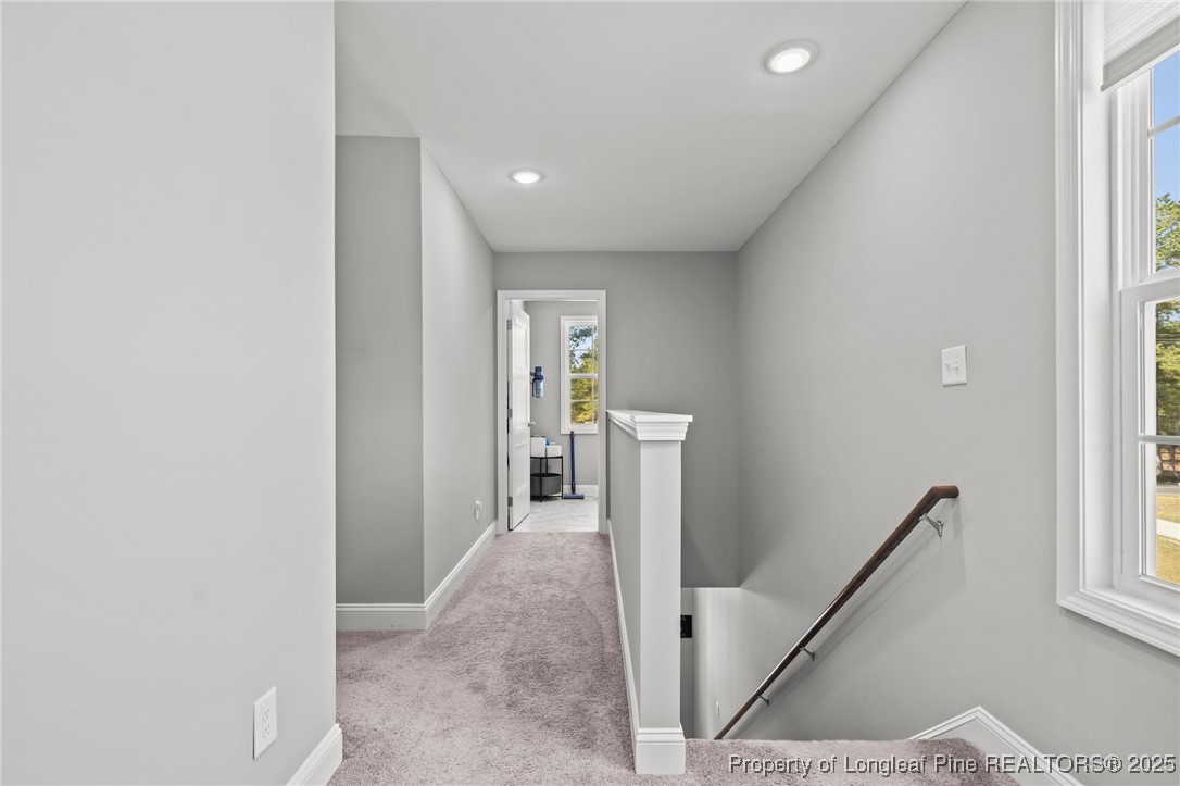6438 Calloway Road Aberdeen, NC 28315 - Photo 22 of 50 a view of a hallway with wooden floor and staircase