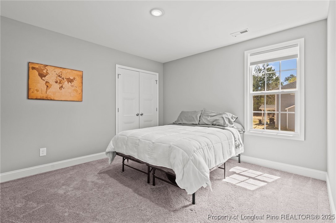 6438 Calloway Road Aberdeen, NC 28315 - Photo 27 of 50 a bedroom with a bed and a window
