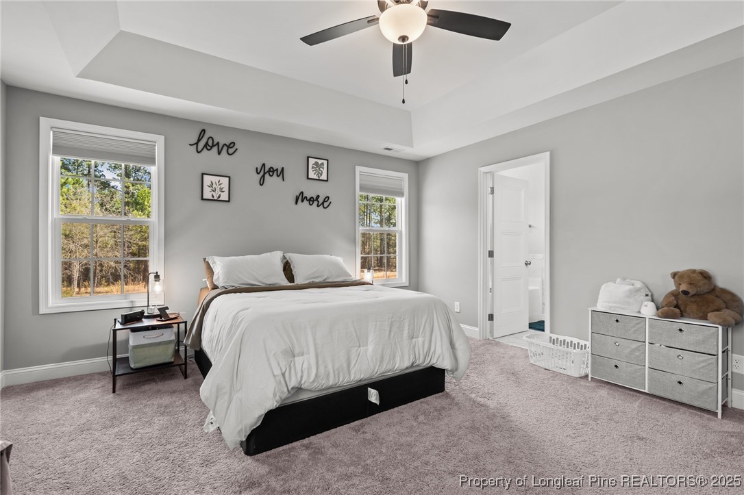 6438 Calloway Road Aberdeen, NC 28315 - Photo 32 of 50 a spacious bedroom with a bed a window and closet
