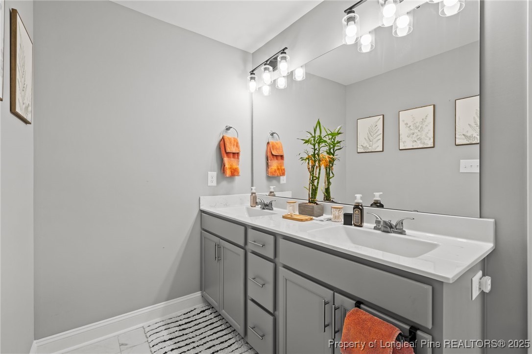 6438 Calloway Road Aberdeen, NC 28315 - Photo 33 of 50 a bathroom with a sink and a mirror