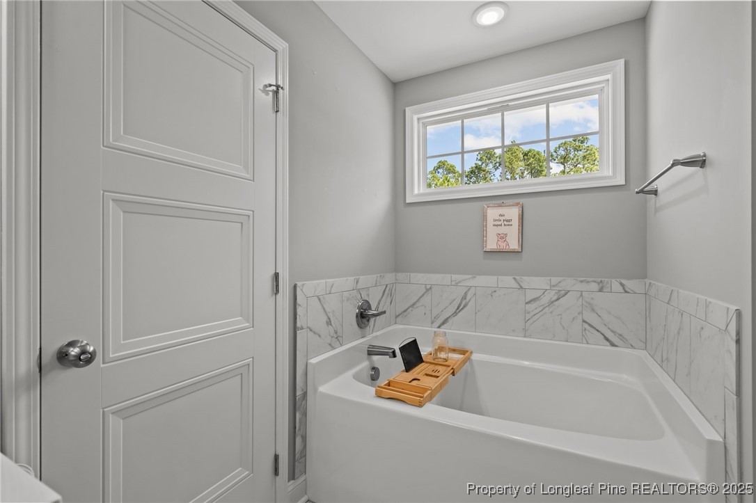 6438 Calloway Road Aberdeen, NC 28315 - Photo 34 of 50 a bath tub sitting next to a window