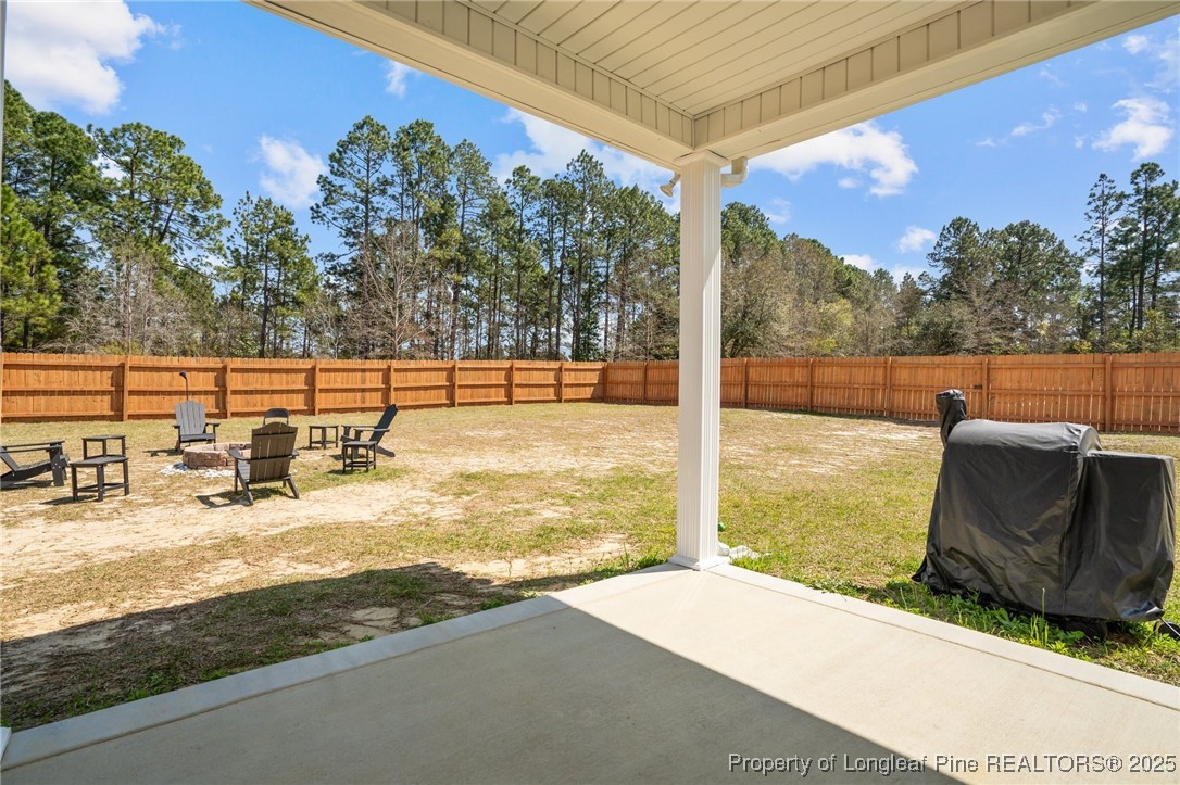 6438 Calloway Road Aberdeen, NC 28315 - Photo 48 of 50 a view of a swimming pool with an outdoor seating and a garden