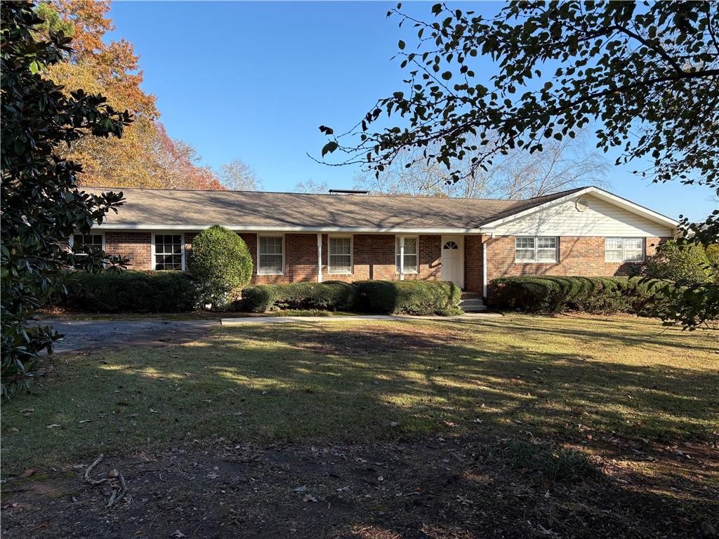 3730 Hurt Bridge Road Cumming, GA 30028 - Photo 1 of 1 a front view of a house with a garden