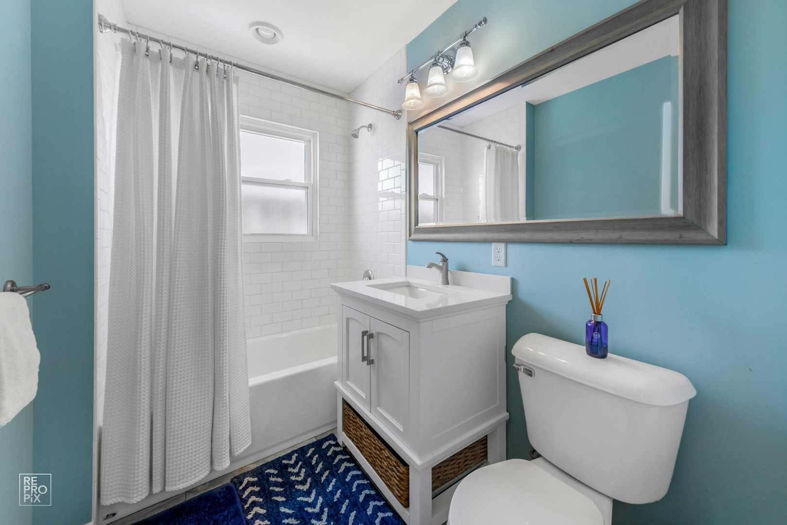 409 Bridle Lane Wheaton, IL 60187 - Photo 8 of 10 a bathroom with a toilet a sink and a mirror