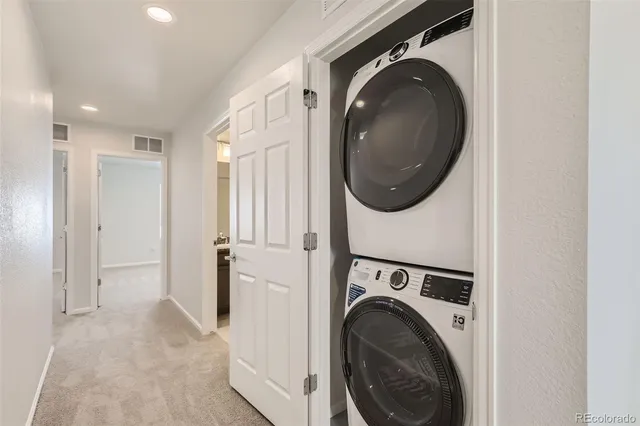 a view of a hallway with washer and dryer
