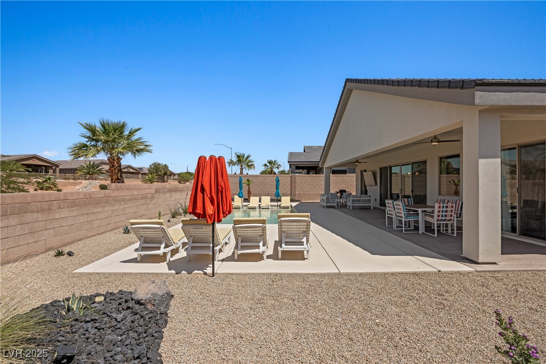 1357 Manassas Ridge Mesquite, NV 89027 - Photo 54 of 72 Fenced backyard featuring a patio, a ceiling fan, and outdoor dining area
