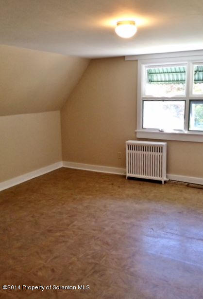 374 Maple Lake Road Moscow, PA 18444 - Photo 21 of 36 an empty room with wooden floor and windows
