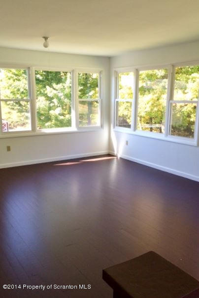 374 Maple Lake Road Moscow, PA 18444 - Photo 23 of 36 an empty room with wooden floor and windows