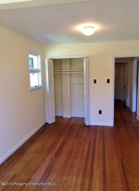 374 Maple Lake Road Moscow, PA 18444 - Photo 9 of 36 a view of an empty room with wooden floor and closet