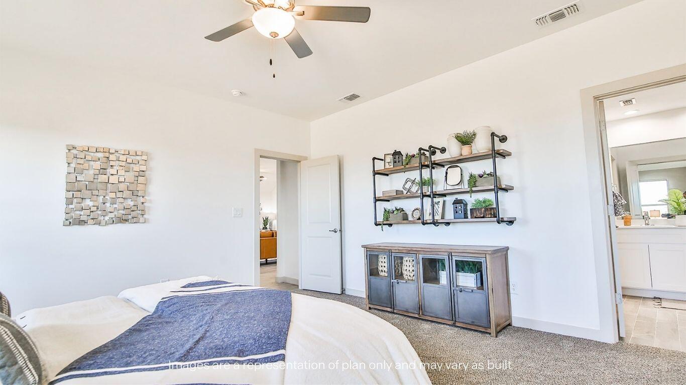 2921 138th Place Lubbock, TX 79423 - Photo 16 of 29 a bedroom with a bed and a fireplace