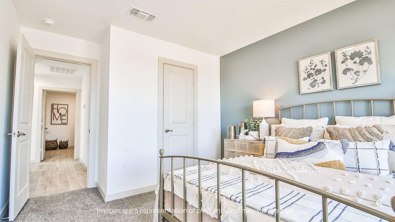 2921 138th Place Lubbock, TX 79423 - Photo 21 of 29 a bedroom with a bed and a view of bathroom