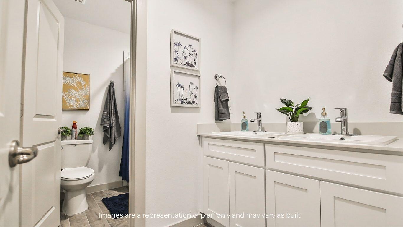 2921 138th Place Lubbock, TX 79423 - Photo 28 of 29 a bathroom with a sink mirror vanity and toilet