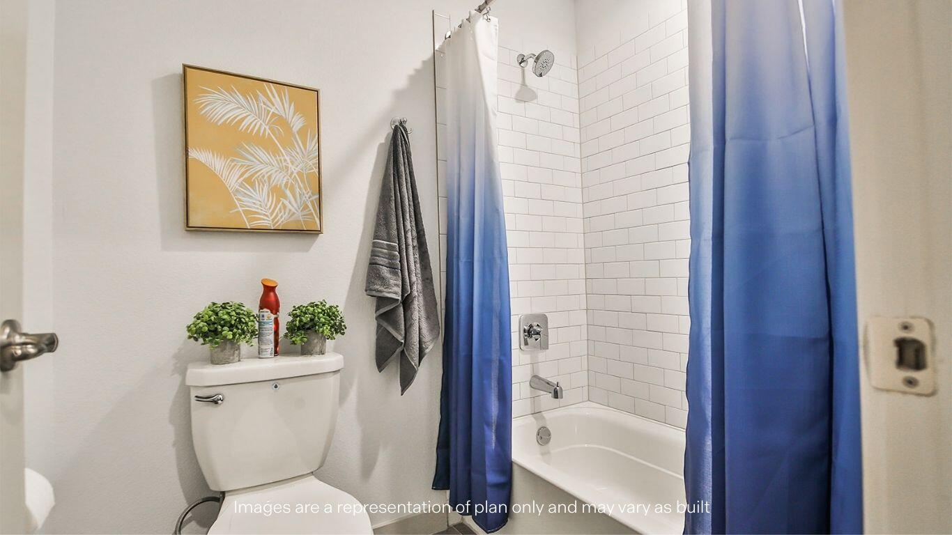 2921 138th Place Lubbock, TX 79423 - Photo 29 of 29 a bathroom with a toilet and a shower curtain