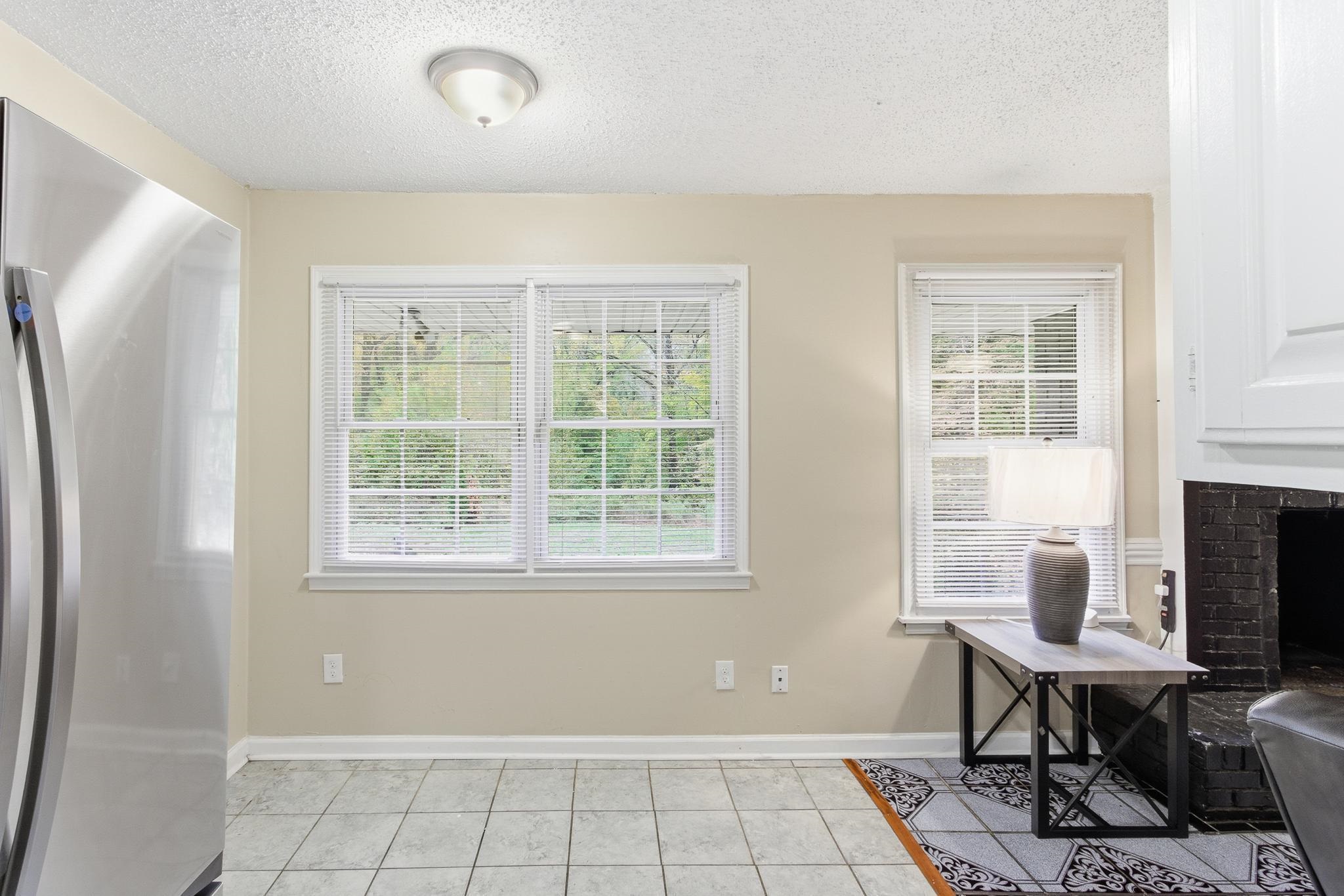 5002 Benjestown Road Memphis, TN 38127 - Photo 11 of 29 Home office with a textured ceiling, light tile patterned floors, and a fireplace