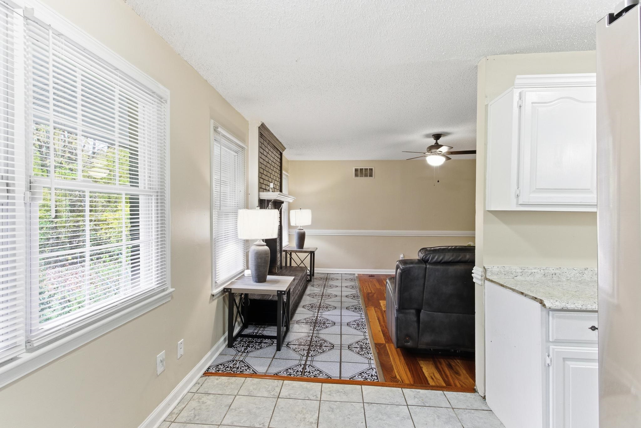 5002 Benjestown Road Memphis, TN 38127 - Photo 12 of 29 Living room with light tile patterned flooring, a textured ceiling, and a ceiling fan