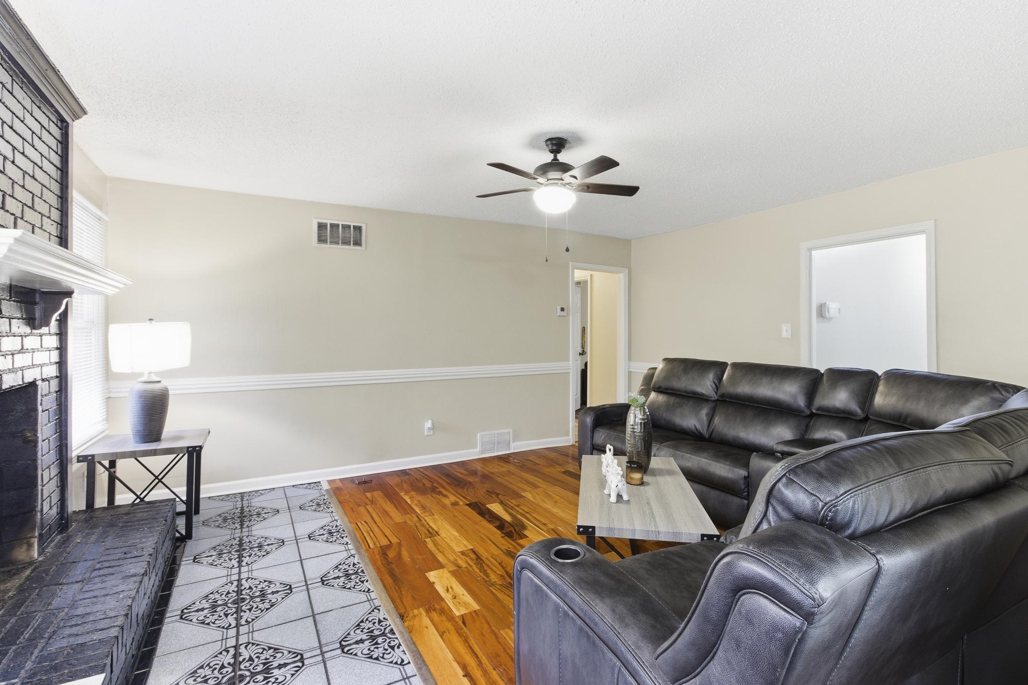 5002 Benjestown Road Memphis, TN 38127 - Photo 13 of 29 Living area with a brick fireplace, wood finished floors, and ceiling fan