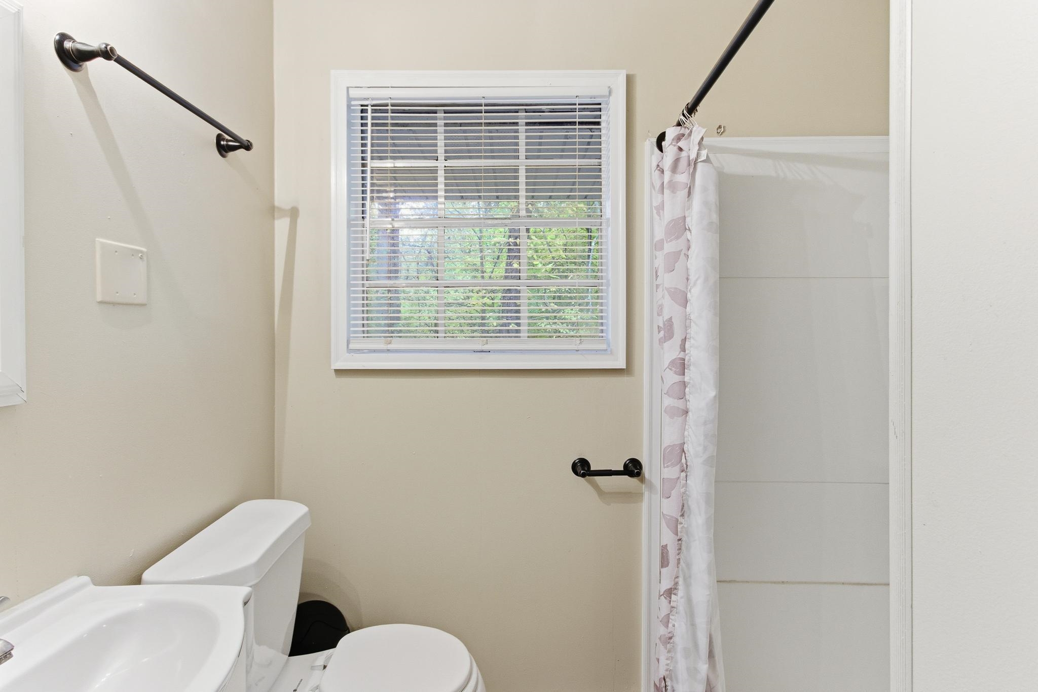5002 Benjestown Road Memphis, TN 38127 - Photo 20 of 29 Full bath featuring a shower with shower curtain and a sink