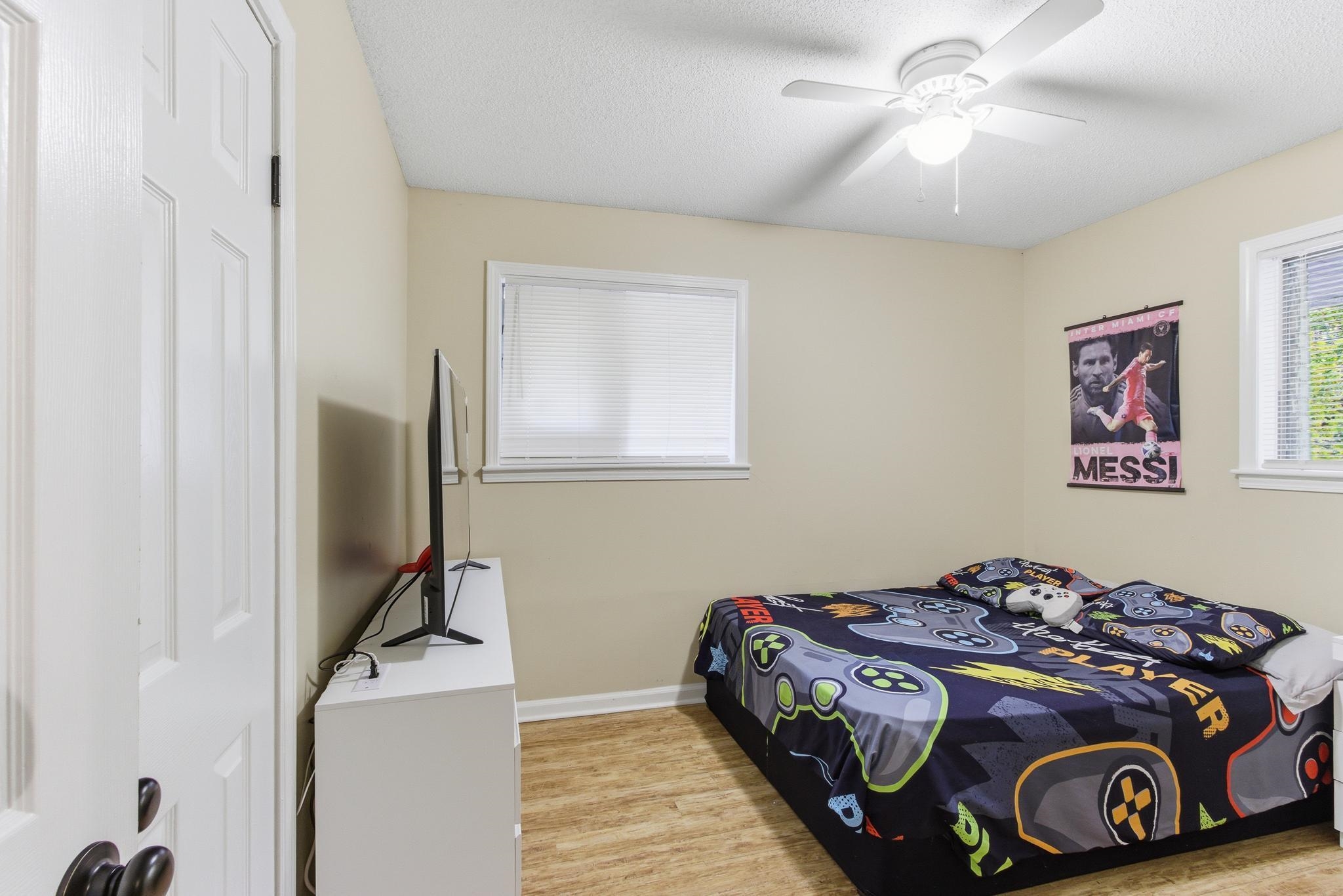 5002 Benjestown Road Memphis, TN 38127 - Photo 21 of 29 Bedroom featuring light wood-style floors, a ceiling fan, and a textured ceiling