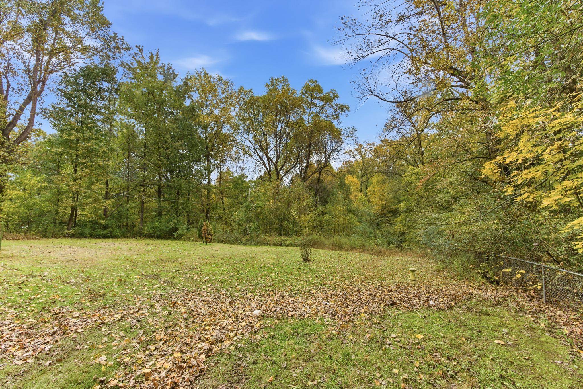 5002 Benjestown Road Memphis, TN 38127 - Photo 25 of 29 View of green lawn featuring a wooded view