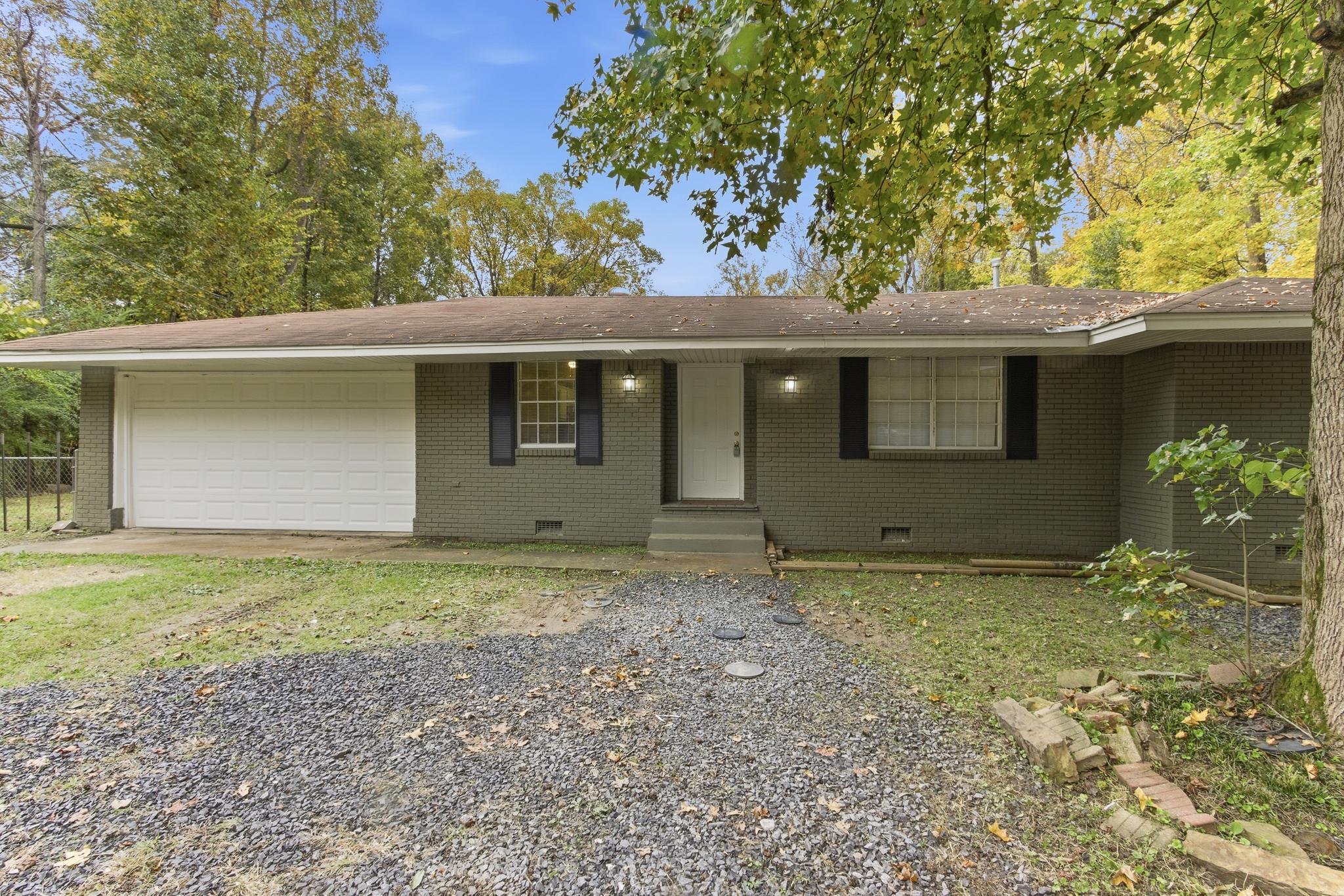 5002 Benjestown Road Memphis, TN 38127 - Photo 3 of 29 Ranch-style home featuring crawl space, driveway, a garage, brick siding, and covered porch